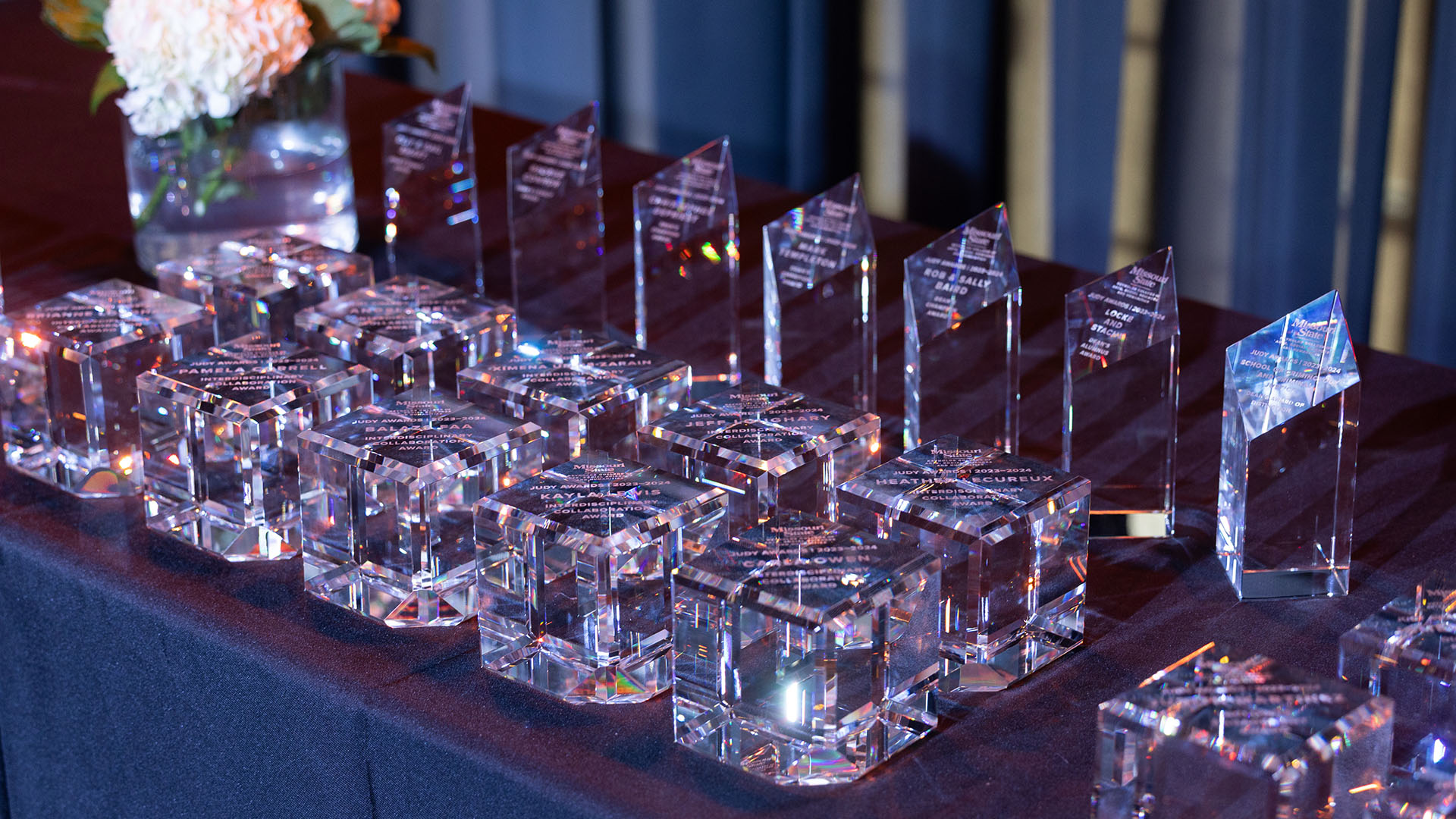 Award trophies lined up on stage table