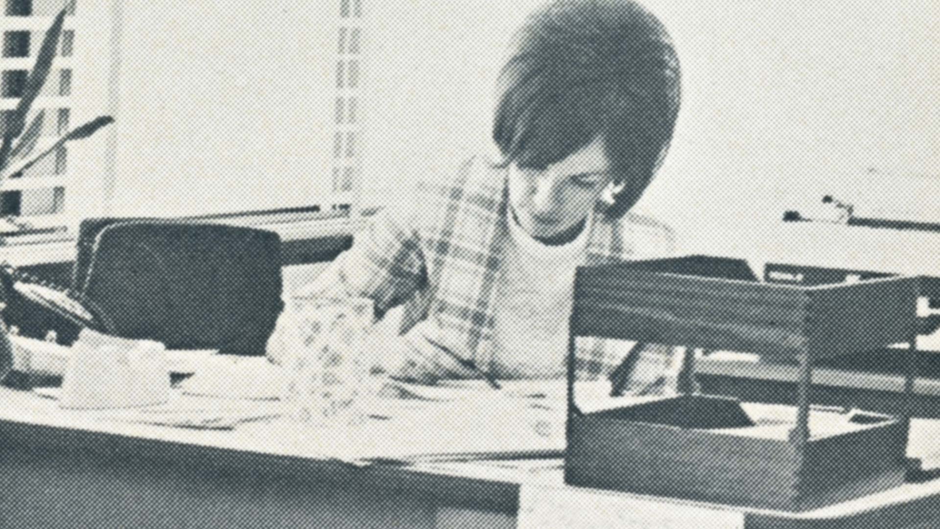 Photo of Judy Reynolds working at her desk at Missouri State University