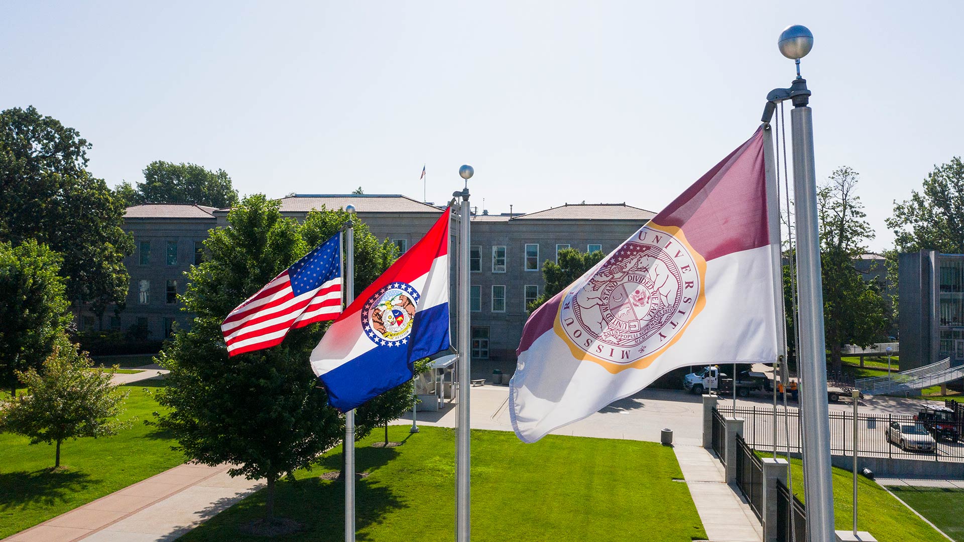 The U.S., Missouri, and Missouri State flags fly on campus